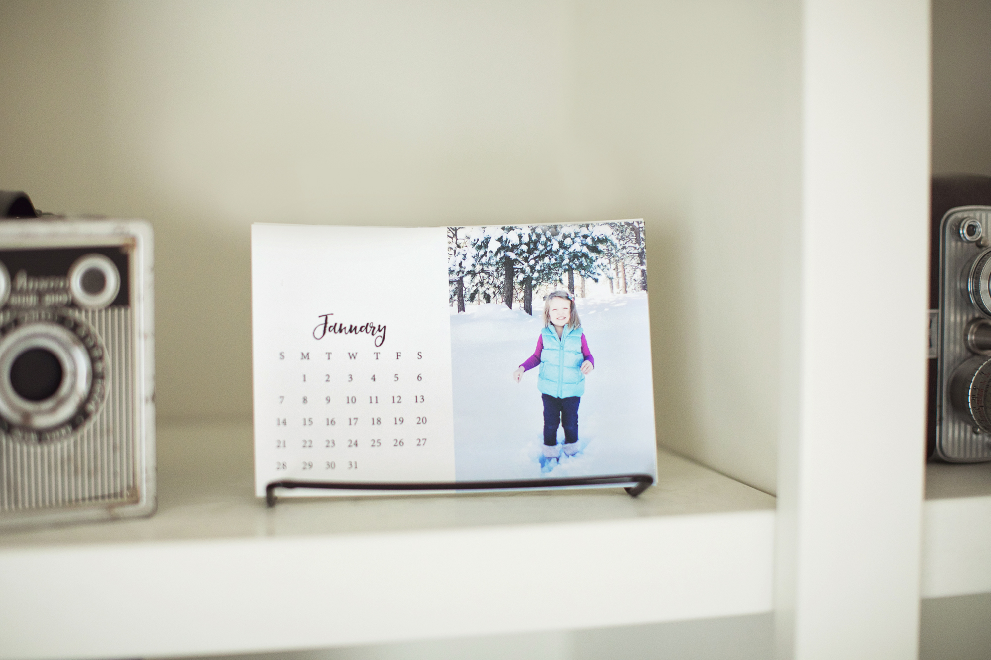 Check out this free download to make your own photo calendar in the Project Life App.  It's a super easy and inexpensive way to make a personalized gift!